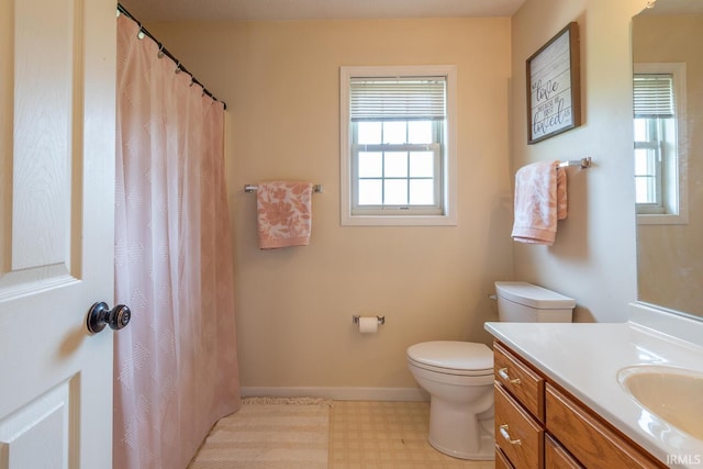 bathroom featuring baseboards, a shower with shower curtain, toilet, vanity, and tile patterned floors