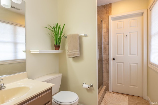 full bathroom featuring tile patterned flooring, toilet, a shower, and vanity
