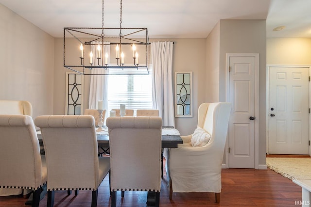 dining room with an inviting chandelier and dark wood finished floors