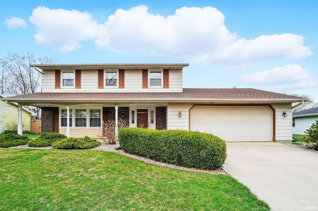 traditional home featuring concrete driveway, a garage, and a front yard