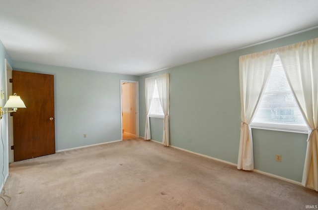 unfurnished bedroom with carpet flooring and baseboards