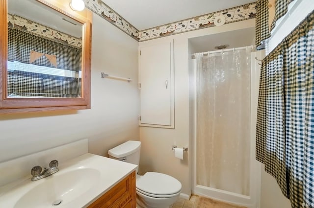 bathroom with toilet, vanity, and a shower with shower curtain