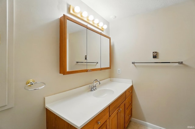 bathroom with baseboards and vanity