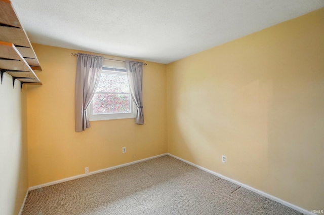 unfurnished room featuring baseboards and carpet floors