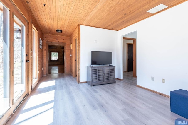 3066 N Pierce Dr, Solsberry, IN 47459 - unfurnished living room with light wood-style floors, visible vents, wooden ceiling, wooden walls, and baseboards