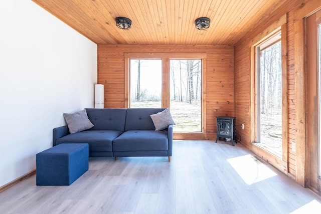 3066 N Pierce Dr, Solsberry, IN 47459 - living area with light wood finished floors, wood ceiling, a wood stove, and wooden walls