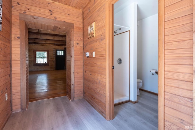 3066 N Pierce Dr, Solsberry, IN 47459 - bathroom featuring a shower stall, toilet, wood finished floors, wood walls, and baseboards