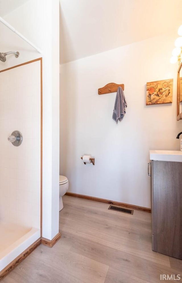3066 N Pierce Dr, Solsberry, IN 47459 - bathroom with a shower stall, vanity, visible vents, toilet, and wood finished floors