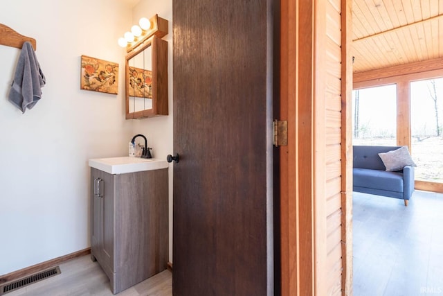3066 N Pierce Dr, Solsberry, IN 47459 - bathroom with visible vents, baseboards, wood ceiling, vanity, and wood finished floors