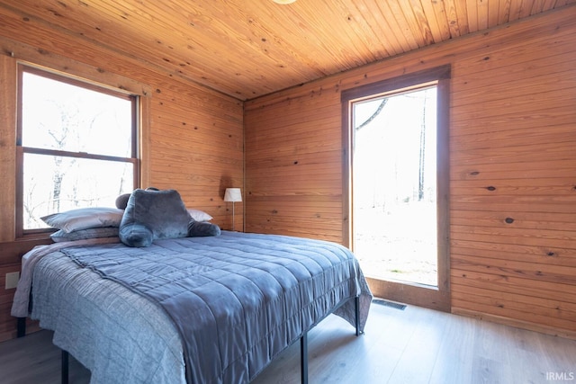 3066 N Pierce Dr, Solsberry, IN 47459 - bedroom featuring wood ceiling, wood finished floors, wood walls, and visible vents