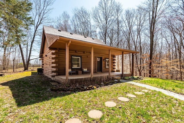 3066 N Pierce Dr, Solsberry, IN 47459 - exterior space with a yard, log exterior, central AC, and covered porch