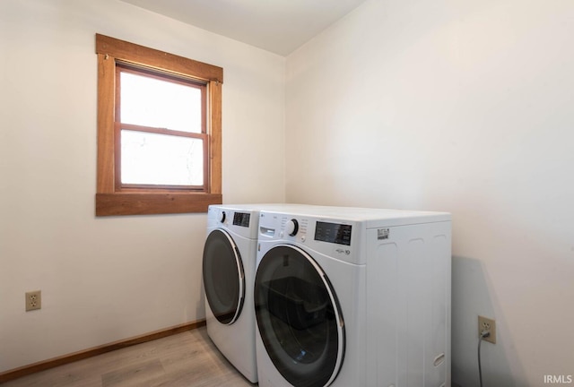 3066 N Pierce Dr, Solsberry, IN 47459 - clothes washing area with washer and dryer, light wood finished floors, laundry area, and baseboards