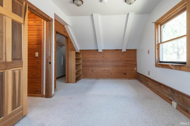 3066 N Pierce Dr, Solsberry, IN 47459 - additional living space with carpet floors, baseboards, lofted ceiling with beams, and wood walls