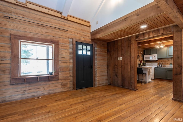 3066 N Pierce Dr, Solsberry, IN 47459 - foyer entrance with wooden walls, light wood-style floors, and beamed ceiling