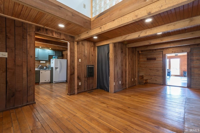 3066 N Pierce Dr, Solsberry, IN 47459 - kitchen featuring wood walls, beamed ceiling, white appliances, and hardwood / wood-style flooring