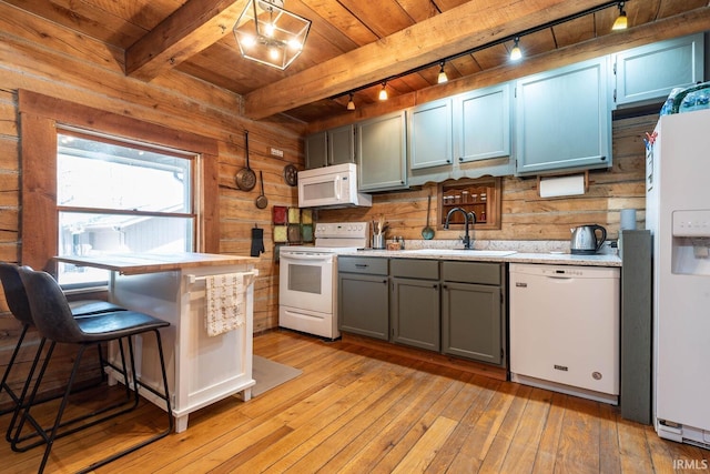 3066 N Pierce Dr, Solsberry, IN 47459 - kitchen with a sink, white appliances, light wood-style floors, wood ceiling, and wood walls