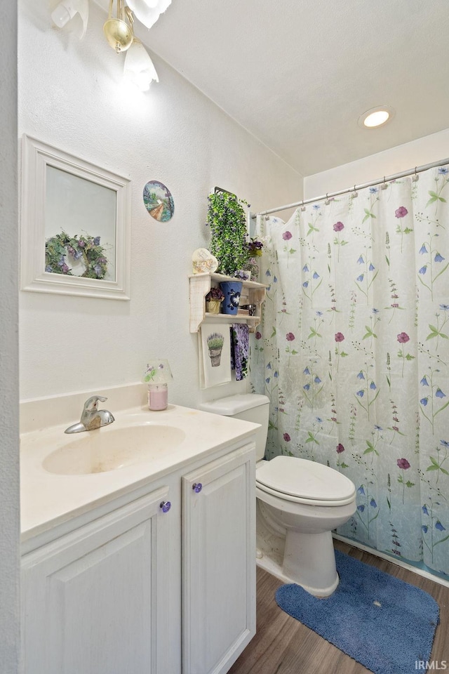 full bathroom with vanity, recessed lighting, toilet, curtained shower, and wood finished floors