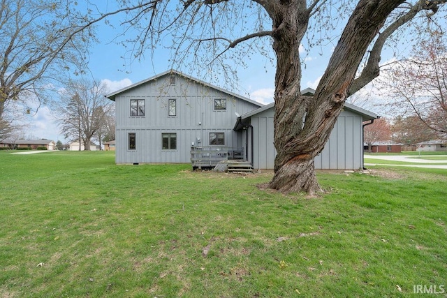 back of property featuring board and batten siding and a lawn