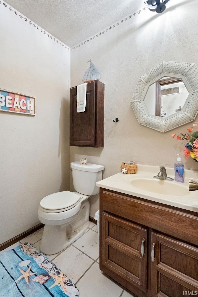 half bath with baseboards, toilet, a textured ceiling, vanity, and tile patterned flooring
