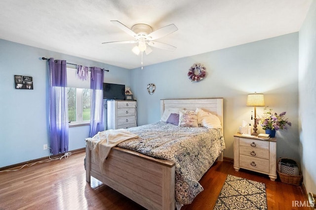 bedroom with wood finished floors, baseboards, and a ceiling fan