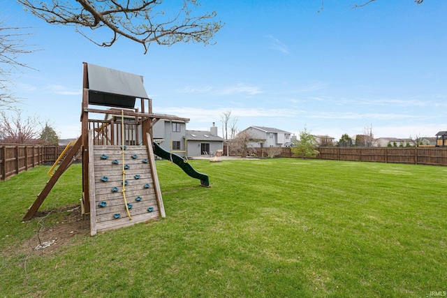 view of play area with a lawn and a fenced backyard
