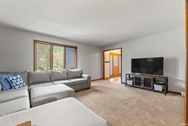 living room featuring baseboards, a textured ceiling, and carpet