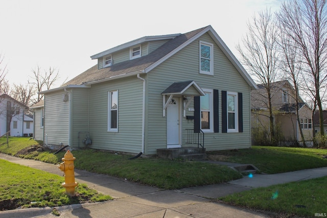bungalow-style home featuring a front lawn