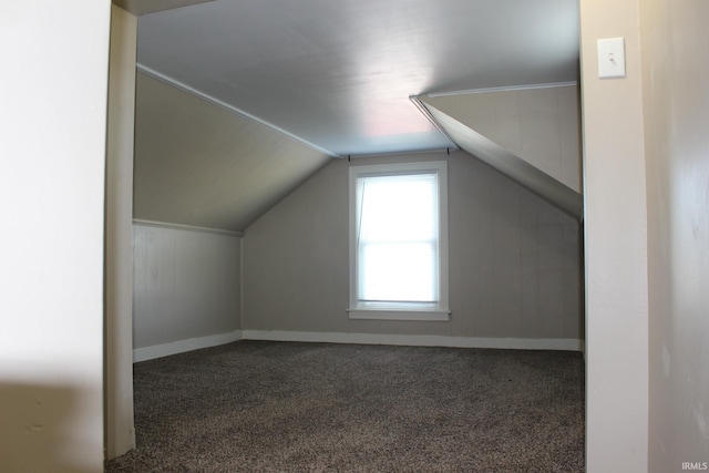 bonus room featuring baseboards, vaulted ceiling, and carpet floors