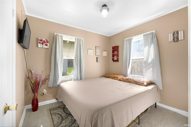 bedroom featuring baseboards, ornamental molding, and carpet floors