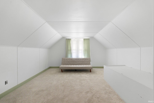 bonus room featuring light colored carpet, baseboards, and lofted ceiling