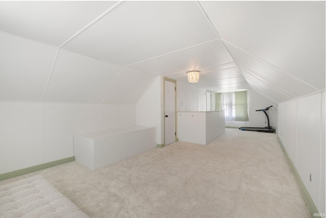 bonus room with vaulted ceiling and carpet floors