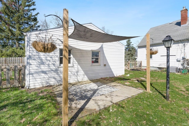 view of home's exterior featuring a yard, a patio area, and fence