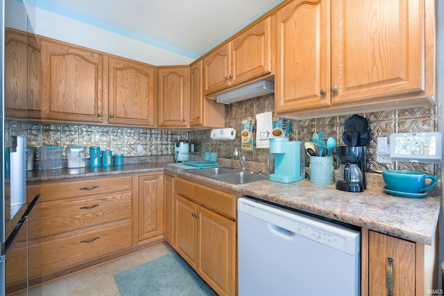 kitchen with light countertops, a sink, backsplash, and white dishwasher
