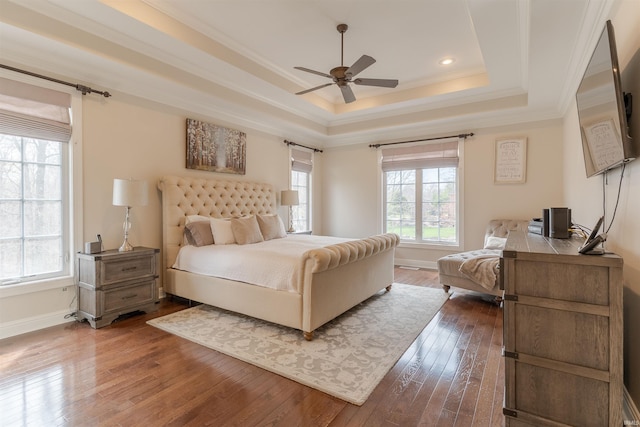 6455 Water Stone Ct, Newburgh, IN 47630 - bedroom featuring baseboards, ornamental molding, dark wood-type flooring, a tray ceiling, and ceiling fan