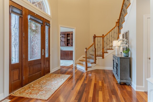 6455 Water Stone Ct, Newburgh, IN 47630 - entrance foyer featuring baseboards, a high ceiling, wood finished floors, and stairs