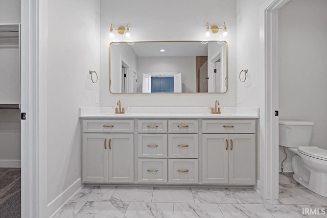 bathroom with baseboards, marble finish floor, a sink, and toilet