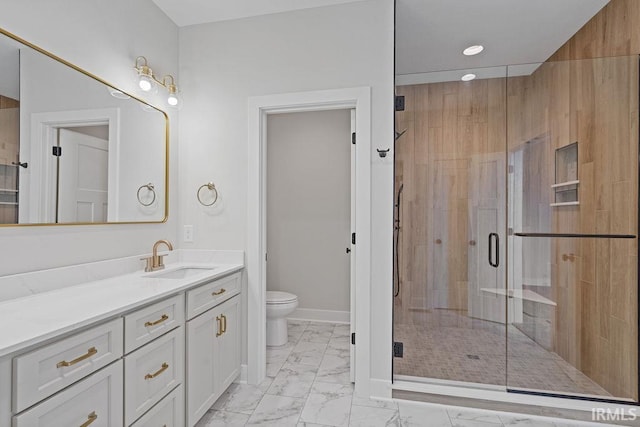 bathroom featuring toilet, a stall shower, marble finish floor, and vanity