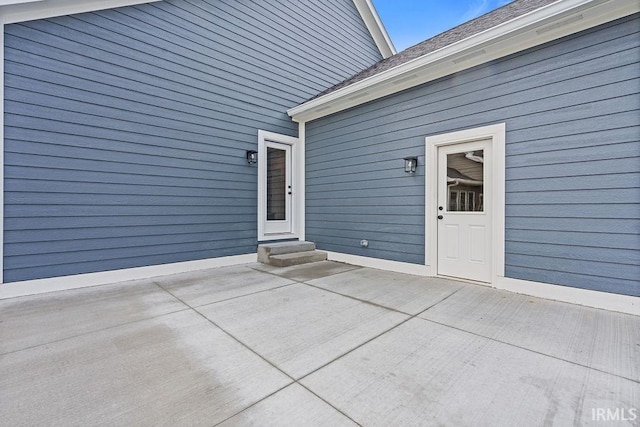 property entrance featuring a patio area