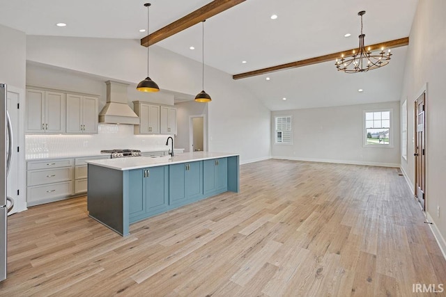 kitchen featuring range, an inviting chandelier, light countertops, premium range hood, and beam ceiling