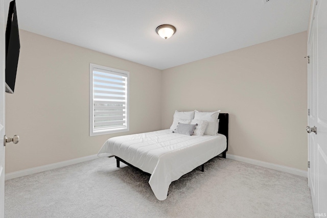 bedroom with carpet flooring and baseboards