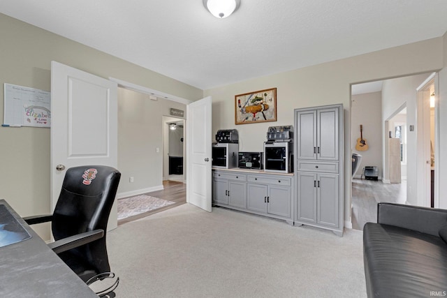 office featuring light colored carpet and baseboards