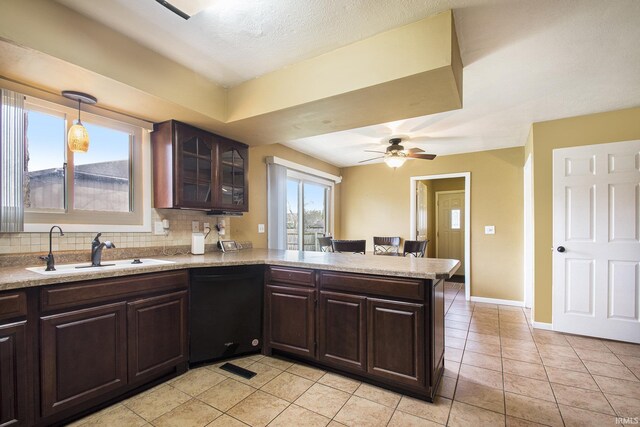 51821 Trowbridge Ln, South Bend, IN 46637 - kitchen featuring dishwasher, a peninsula, dark brown cabinetry, and a sink