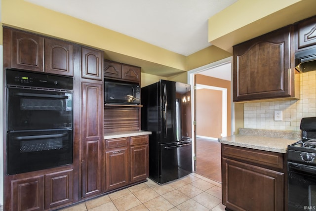51821 Trowbridge Ln, South Bend, IN 46637 - kitchen featuring light countertops, dark brown cabinets, light tile patterned floors, decorative backsplash, and black appliances