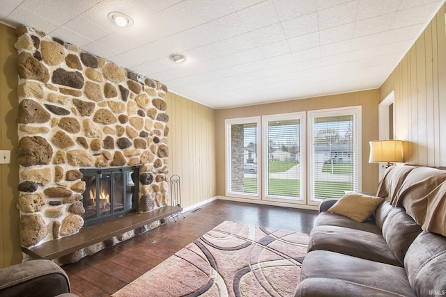 51821 Trowbridge Ln, South Bend, IN 46637 - living area featuring visible vents, wood finished floors, wooden walls, and a fireplace