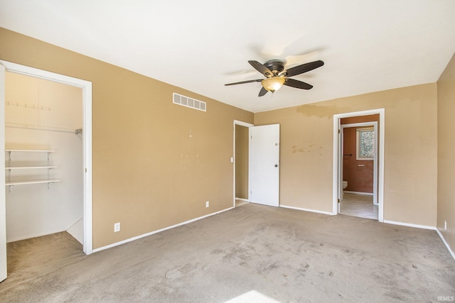 51821 Trowbridge Ln, South Bend, IN 46637 - unfurnished bedroom featuring a walk in closet, connected bathroom, carpet floors, baseboards, and visible vents