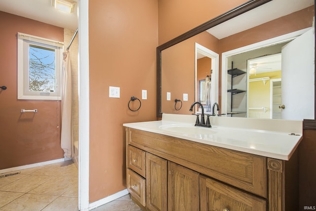 51821 Trowbridge Ln, South Bend, IN 46637 - bathroom with visible vents, baseboards, a ceiling fan, tile patterned flooring, and vanity