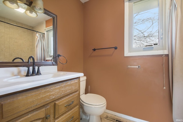 51821 Trowbridge Ln, South Bend, IN 46637 - full bathroom with toilet, vanity, tile patterned floors, and visible vents