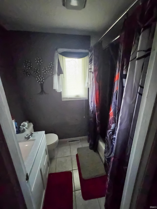51821 Trowbridge Ln, South Bend, IN 46637 - full bathroom with vanity, toilet, tile patterned flooring, and baseboards