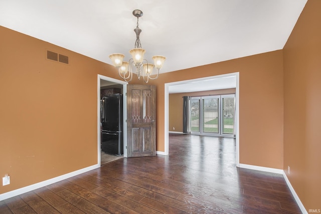51821 Trowbridge Ln, South Bend, IN 46637 - spare room with hardwood / wood-style flooring, baseboards, a chandelier, and visible vents