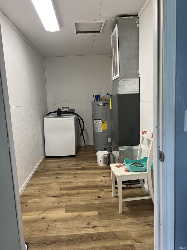 utility room featuring water heater and washer / dryer